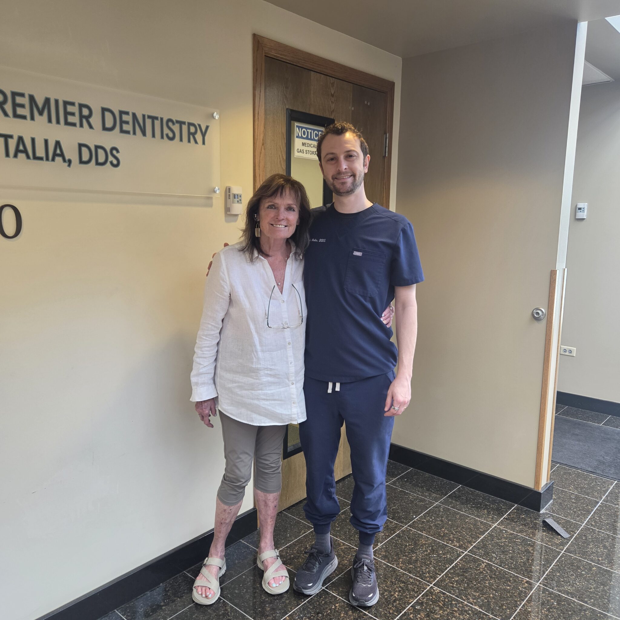 Kathleen and Dr Italia in front of signage